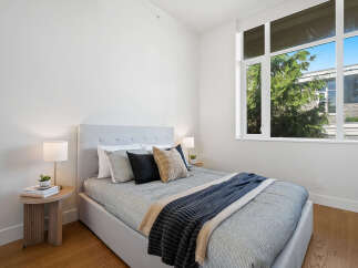 Experience modern comfort in this beautifully appointed bedroom, featuring a plush bed with a stylish upholstered headboard.
