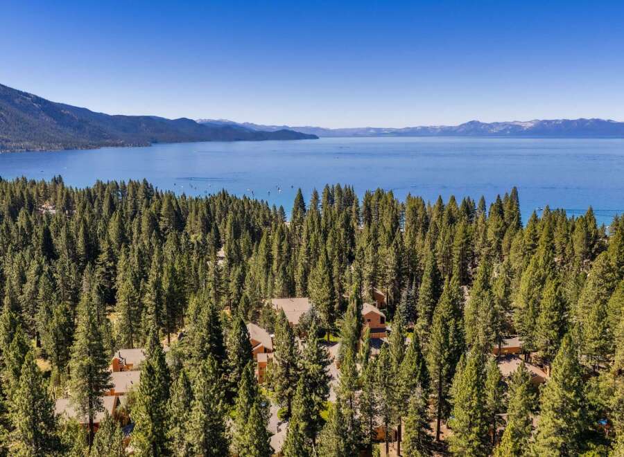 Experience breathtaking lake views from this stunning property nestled amidst a dense pine forest.