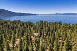 Experience breathtaking lake views from this stunning property nestled amidst a dense pine forest.