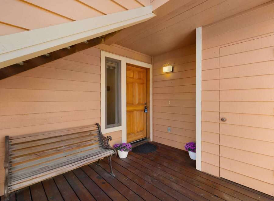 Welcome guests to this charming home with a covered porch, perfect for enjoying the outdoors.