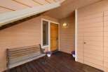 Welcome guests to this charming home with a covered porch, perfect for enjoying the outdoors.