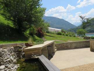 Discover this charming property with a picturesque view of the mountains and a serene lake.