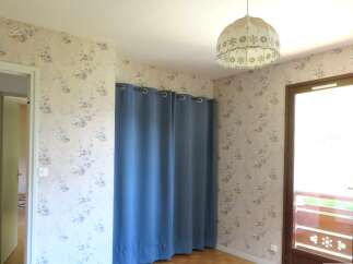 This charming room features a delicate floral wallpaper that adds a touch of vintage elegance.
