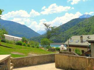 Discover this charming property nestled in a picturesque mountain landscape with a serene lake view.