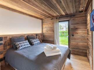 Experience rustic charm and modern comfort in this beautifully appointed bedroom.