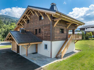 Experience rustic charm and modern comfort in this stunning wooden chalet, nestled amidst breathtaking mountain scenery.