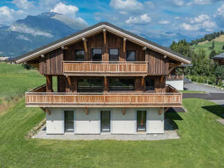 Experience luxury mountain living in this stunning wooden chalet, featuring expansive balconies with breathtaking views of the surrounding Alps.