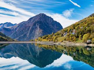 Discover a serene mountain village nestled beside a tranquil lake, offering breathtaking views and a peaceful lifestyle.