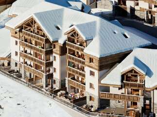 Experience luxury mountain living in this stunning chalet-style property, featuring expansive balconies perfect for enjoying breathtaking snowy vistas.
