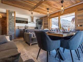 Experience luxurious mountain living in this stunning alpine retreat, featuring a spacious open-plan living, dining, and kitchen area perfect for entertaining.