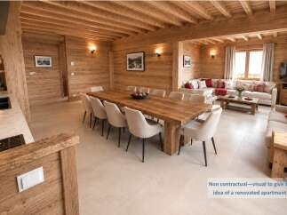 Experience rustic charm in this beautifully renovated apartment, featuring a spacious dining area with a large wooden table perfect for gatherings.
