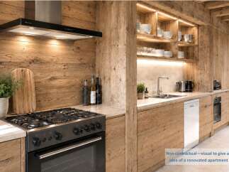 Experience rustic charm in this beautifully renovated apartment kitchen, featuring warm wooden cabinetry and a sleek black range hood.