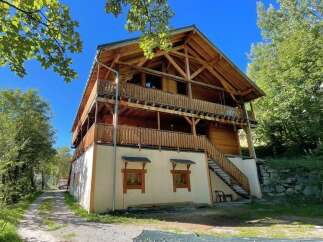 Discover this stunning multi-story wooden chalet, featuring expansive balconies and a unique architectural design.