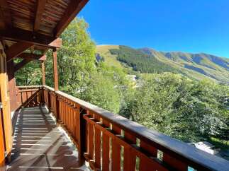 Enjoy breathtaking mountain views from this charming wooden balcony, perfect for your morning coffee or evening relaxation.
