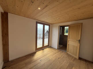 Experience rustic charm and modern comfort in this beautifully appointed room featuring warm wooden ceilings and floors.
