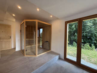 Experience ultimate relaxation in this modern home featuring a luxurious glass-enclosed sauna.