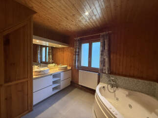 Experience luxury in this stunning bathroom featuring a spacious jacuzzi tub and a double vanity with elegant vessel sinks.