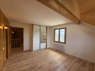 Discover this charming room featuring a spacious built-in wardrobe with mirrored doors, perfect for ample storage.