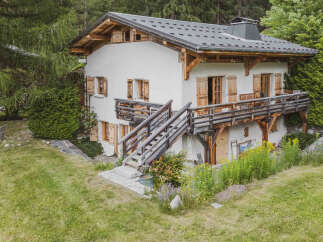 Nestled amidst lush greenery, this charming chalet offers a serene mountain retreat.