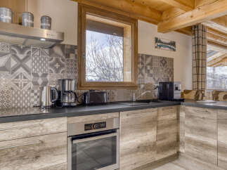 Experience the charm of this mountain kitchen, featuring a modern coffee maker and toaster for your morning routine.
