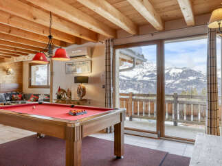 Experience the ultimate mountain getaway in this charming chalet, featuring a full-size pool table perfect for evening entertainment.