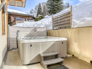 Experience ultimate relaxation in this luxurious outdoor hot tub, perfect for unwinding after a day on the slopes.