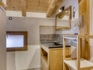 Discover this charming bathroom featuring a sleek wooden vanity with a dark countertop and a modern faucet.