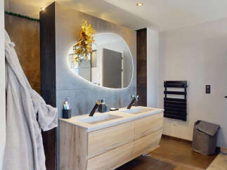 Experience modern luxury in this stunning bathroom featuring a double vanity with sleek faucets and ample storage.