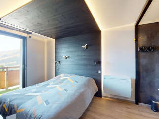 Experience mountain living in this stylish bedroom featuring a modern design with dark wood accents and a geometric duvet cover.