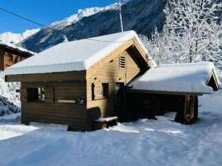 Experience the charm of this rustic wooden cabin nestled in a serene winter wonderland.