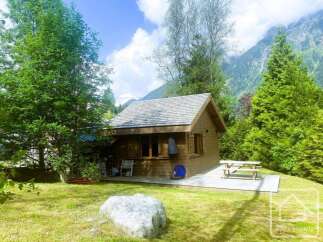 Nestled amidst lush greenery and majestic mountains, this charming wooden cabin offers a serene retreat.