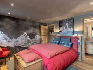 Experience the ultimate mountain retreat in this stunning bedroom, featuring a dramatic mural of snow-capped peaks that brings the outdoors in.