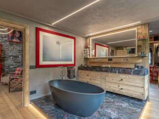 Experience luxury in this stunning bathroom featuring a freestanding oval bathtub on a dramatic marble floor.
