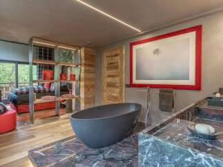 Experience luxury in this stunning master suite, featuring a freestanding bathtub and a spacious marble vanity.
