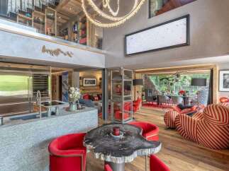 Experience luxury living in this stunning open-plan space, featuring a modern kitchen with sleek stainless steel appliances and a granite island.