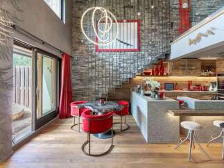 Experience luxury mountain living in this stunning open-concept space, featuring a modern kitchen with sleek cabinetry and a granite island perfect for entertaining.