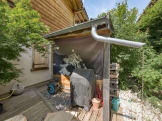 Discover this charming outdoor space featuring a covered grill area, perfect for summer barbecues.