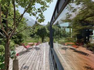 Enjoy the serene mountain views from this charming wooden deck, perfect for outdoor relaxation.