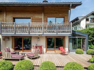 Experience outdoor living at its finest on this expansive wooden deck, perfect for entertaining or relaxing.