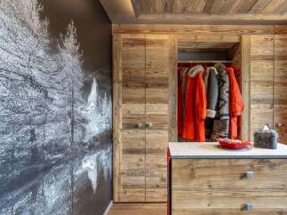 Experience rustic charm in this mountain retreat, featuring a stunning mural of a winter forest scene that complements the warm, natural wood finishes throughout.