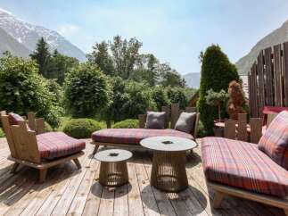 Experience breathtaking mountain views from this stunning outdoor living space, perfect for relaxation and entertaining.