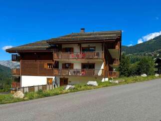 Experience luxury mountain living in this stunning chalet-style property, featuring expansive wooden balconies perfect for enjoying breathtaking alpine views.