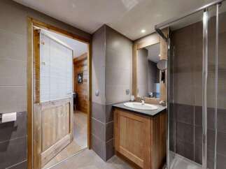 Experience modern comfort in this beautifully appointed bathroom, featuring a sleek vanity with a basin and a spacious glass-enclosed shower.