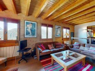 Experience cozy mountain living in this charming wooden cabin, featuring a spacious living area with comfortable leather sofas and a rustic coffee table.