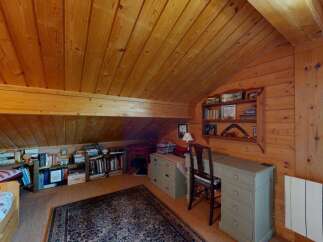 Discover this charming attic room, perfect for a cozy study or guest space.