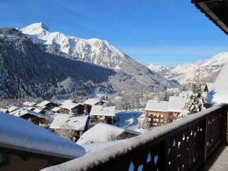 Experience the ultimate winter wonderland from this stunning property, boasting breathtaking panoramic views of snow-capped mountains and a charming alpine village.