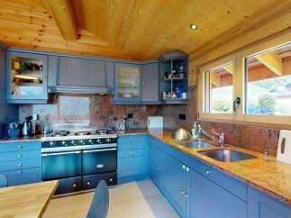 Experience rustic charm in this beautifully appointed kitchen, featuring custom blue cabinetry and a striking granite countertop.