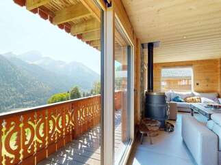 Experience breathtaking mountain views from this charming wooden chalet, featuring a spacious balcony perfect for enjoying the alpine scenery.