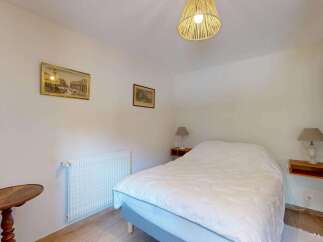 Discover this charming bedroom featuring a comfortable double bed adorned with a crisp white duvet.