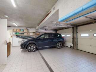 This spacious garage offers ample parking for your vehicles with its two large overhead doors.
